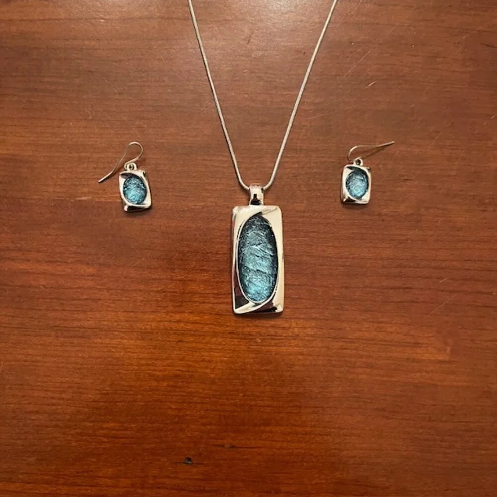 Aqua blue glass pendant and silver tone chain with matching earrings